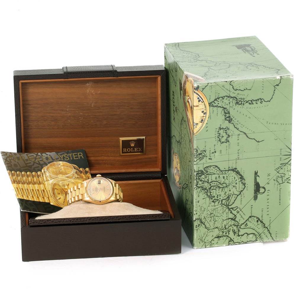 The image shows a Rolex President 18078 Men
s Yellow Gold Champagne Dial 18078 Men
s Yellow Gold Champagne Dial model watch inside its open wooden box, with an outer green box and an informational booklet.