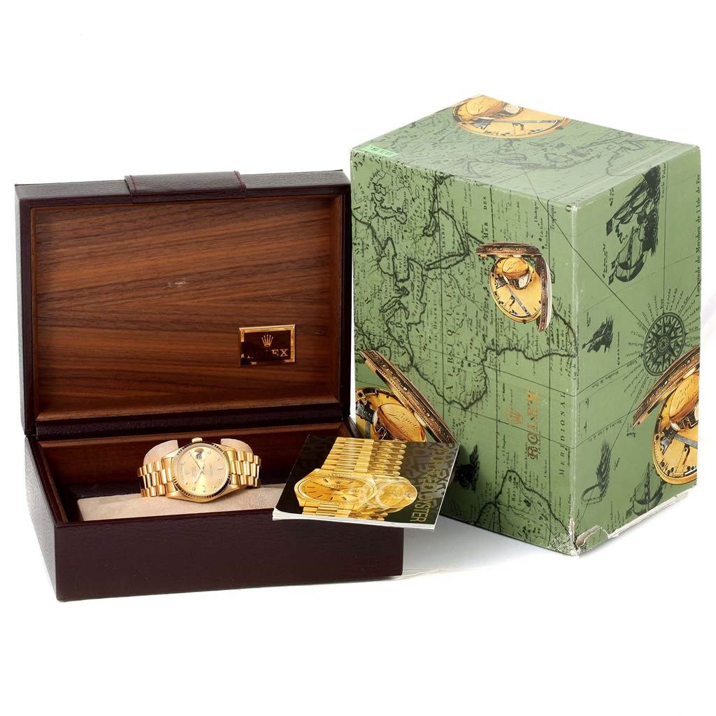 The image shows the Rolex President 18238 Men
s Yellow Gold Champagne Dial 18238 Men
s Yellow Gold Champagne Dial model watch inside an open wooden box with its green-themed outer box and booklet.