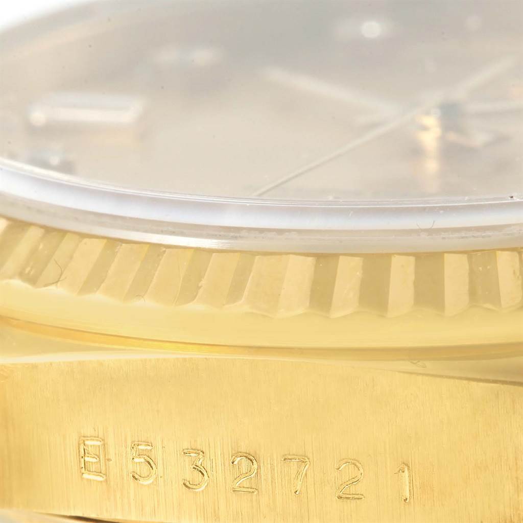 The image shows a close-up of the bezel and part of the serial number of a Rolex President 18238 Men
s Yellow Gold Champagne Dial 18238 Men
s Yellow Gold Champagne Dial model watch.