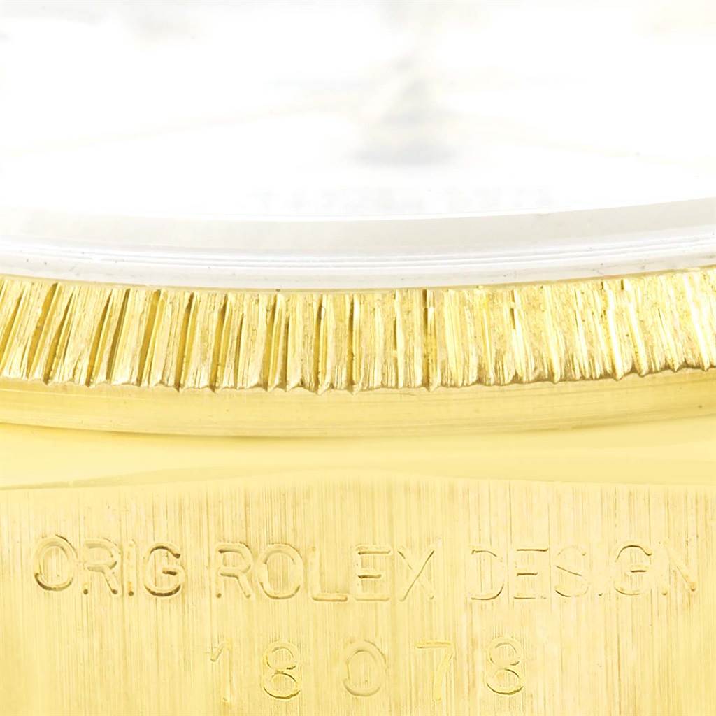 This image shows a close-up of the gold bezel and part of the casing with engraved text on the Rolex President 18078 Men
s Yellow Gold White Dial 18078 Men
s Yellow Gold White Dial model watch.