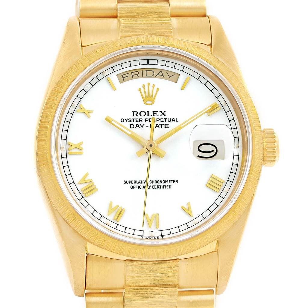 The image shows a frontal view of a Rolex President 18078 Men
s Yellow Gold White Dial 18078 Men
s Yellow Gold White Dial model watch, featuring its dial, day-date display, and part of the gold bracelet.