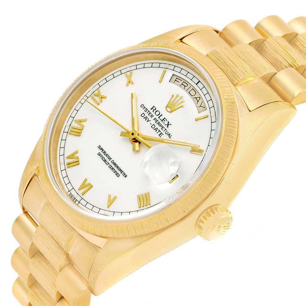 This is a close-up angled view of a Rolex President 18078 Men
s Yellow Gold White Dial 18078 Men
s Yellow Gold White Dial model watch showing the face, bezel, crown, and part of the bracelet.