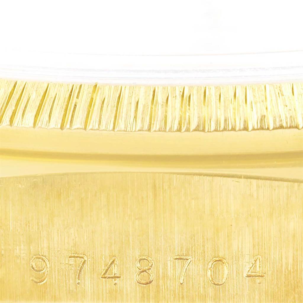 This image shows a close-up of the serial number and fluted bezel of a Rolex President 18078 Men
s Yellow Gold White Dial 18078 Men
s Yellow Gold White Dial watch.