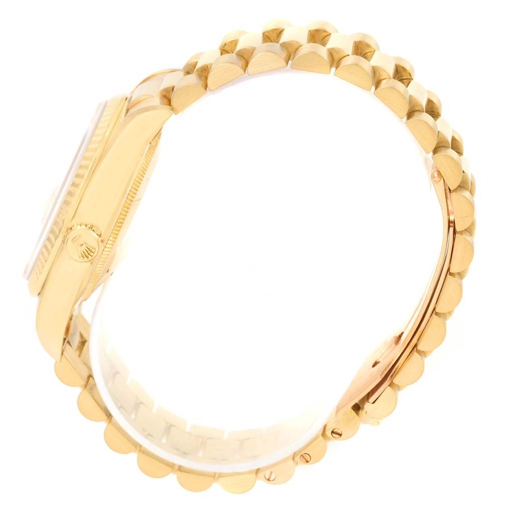 The image shows a President model by Rolex from a side angle, highlighting the gold case and the President bracelet.