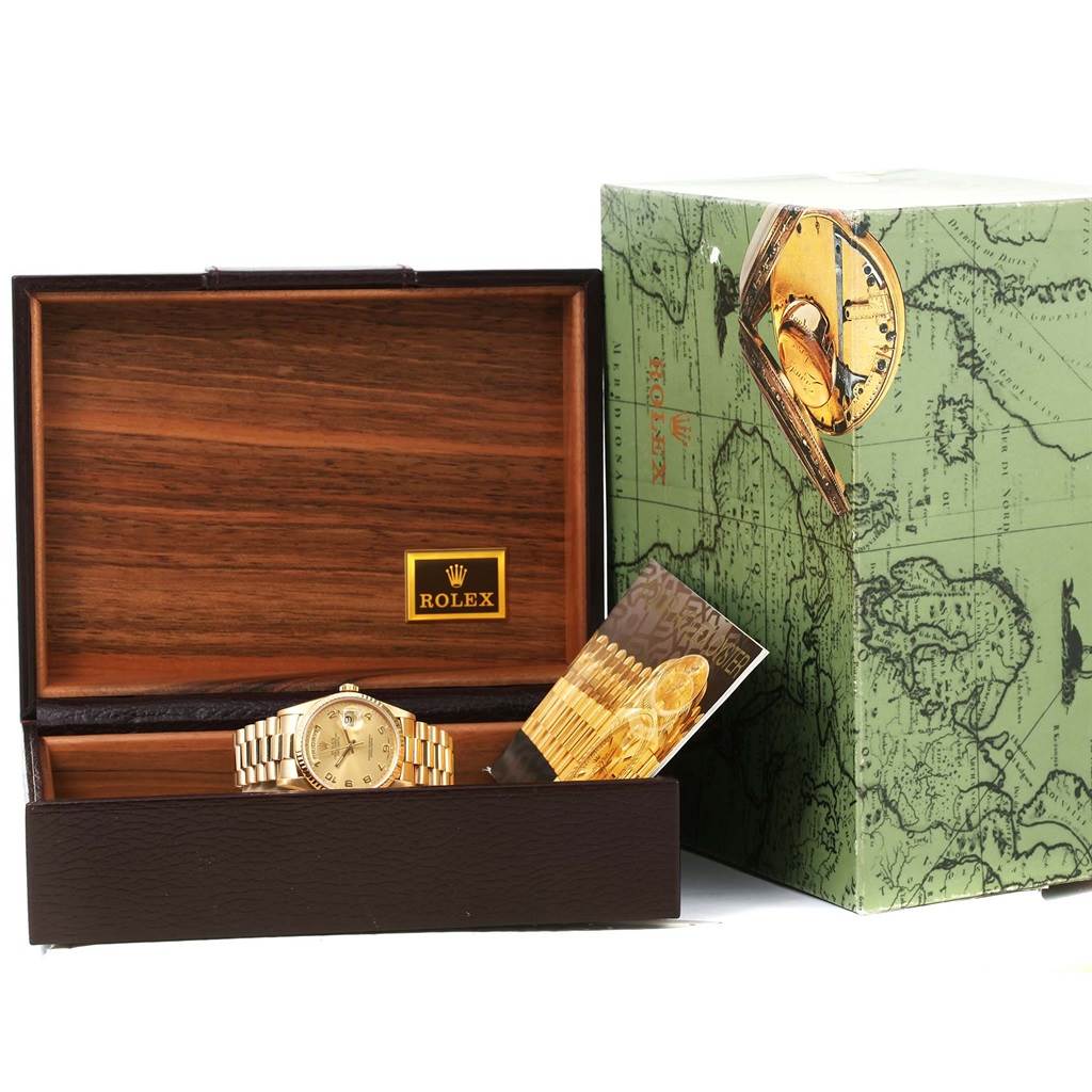 The image shows a Rolex President 18238 Men
s Yellow Gold Champagne Dial 18238 Men
s Yellow Gold Champagne Dial model watch inside an open wooden box with branded packaging and a booklet.