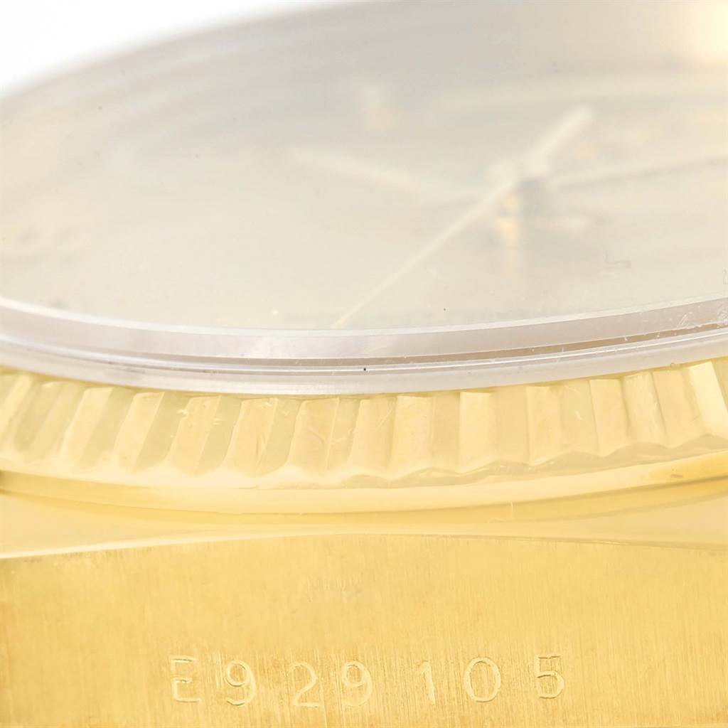 This close-up angle of the Rolex President 18238 Men
s Yellow Gold Champagne Dial 18238 Men
s Yellow Gold Champagne Dial model shows the watch
s bezel, part of the crystal, and the engraved serial number.