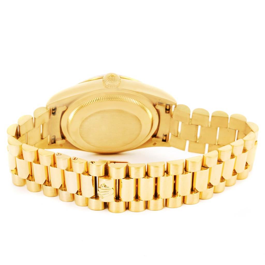 The image shows the back view of a gold Rolex President 18238 Men
s Yellow Gold Champagne Dial 18238 Men
s Yellow Gold Champagne Dial model watch, highlighting the case back and part of the bracelet.