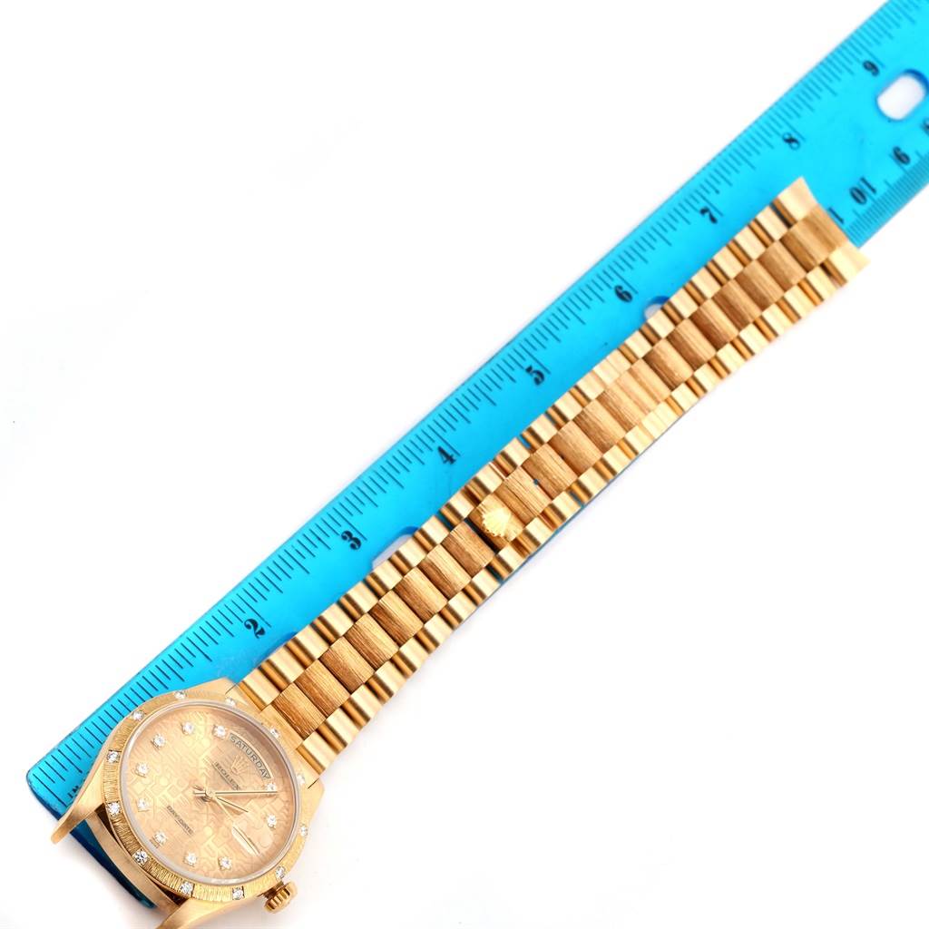 The image shows the face and bracelet of a Rolex President 18308 Men's Yellow Gold Champagne Dial 18308 Men's Yellow Gold Champagne Dial model watch measured against a blue ruler.