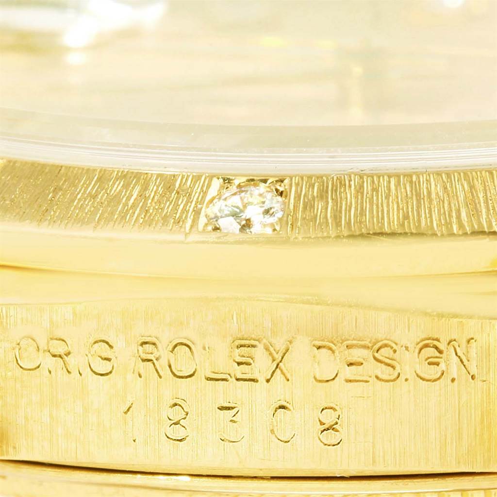 The image shows a close-up of the gold casing and engraved serial number of a Rolex President 18308 Men's Yellow Gold Champagne Dial 18308 Men's Yellow Gold Champagne Dial model watch.