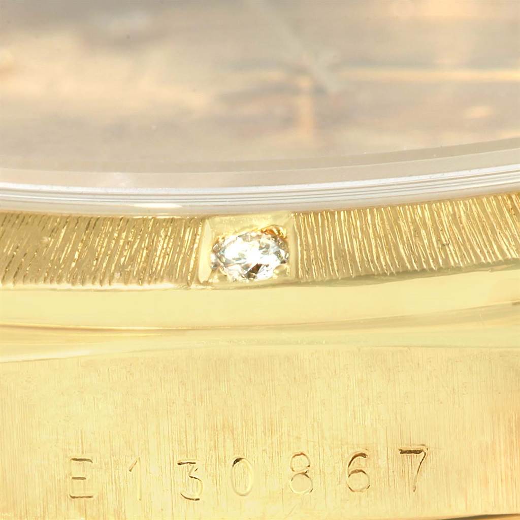 This close-up image shows the serial number and diamond-set bezel of a Rolex President 18308 Men's Yellow Gold Champagne Dial 18308 Men's Yellow Gold Champagne Dial model watch.
