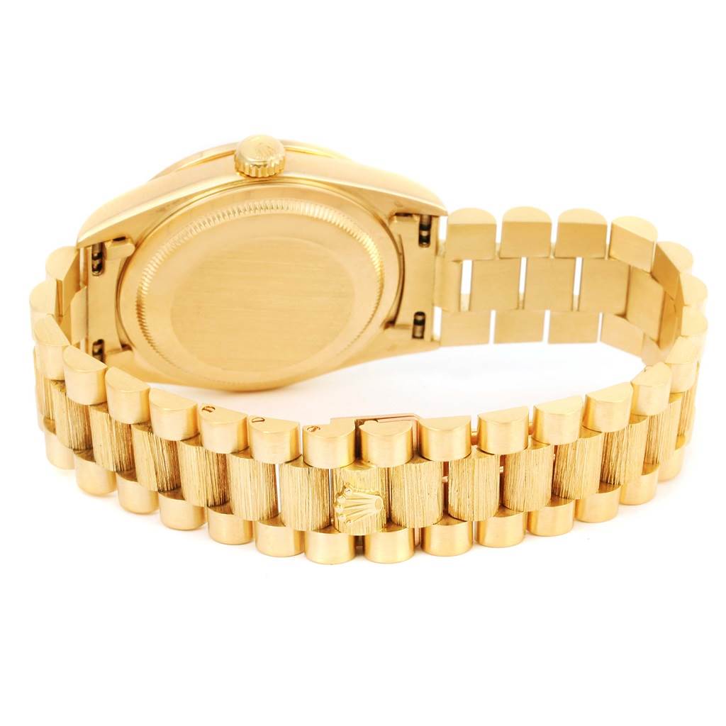 The image shows the back case and bracelet of a Rolex President 18308 Men's Yellow Gold Champagne Dial 18308 Men's Yellow Gold Champagne Dial model watch from an angle that highlights the closure and links.