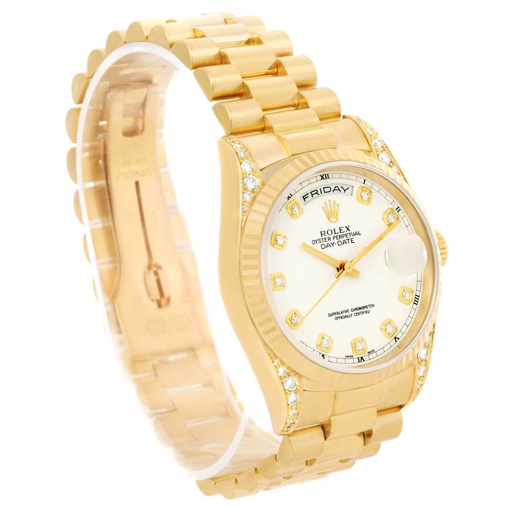 The image shows a Rolex President 18338 Men's Yellow Gold White Dial 18338 Men's Yellow Gold White Dial model watch at an angle highlighting the gold bracelet, diamond-studded bezel, and face with date display.
