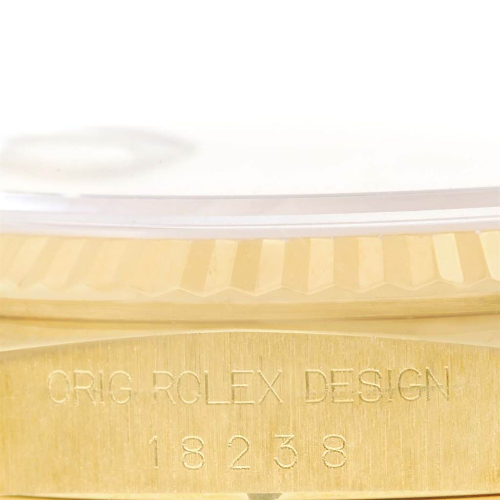 This image shows a close-up of the engraved side of the Rolex President 18238 Men's Yellow Gold White Dial 18238 Men's Yellow Gold White Dial model watch with partial bezel detail.