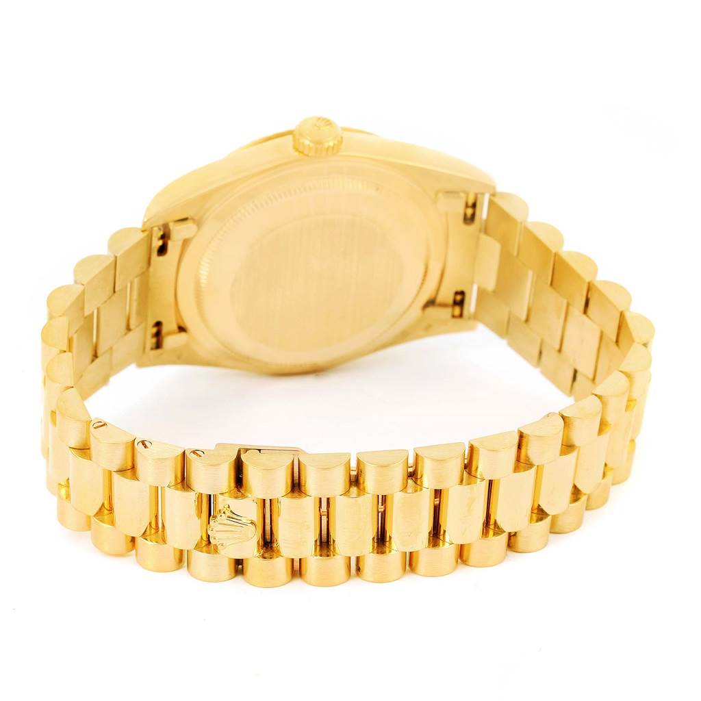 The image shows the back view of a Rolex President 18238 Men's Yellow Gold White Dial 18238 Men's Yellow Gold White Dial model watch including its gold case, crown, and bracelet.