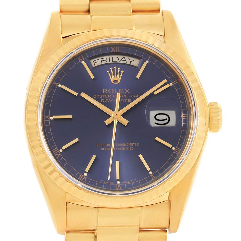 The image shows a Rolex President 18038 Men
s Yellow Gold Blue Dial 18038 Men
s Yellow Gold Blue Dial model watch from a front angle, highlighting its blue dial, day and date displays, and gold bracelet.