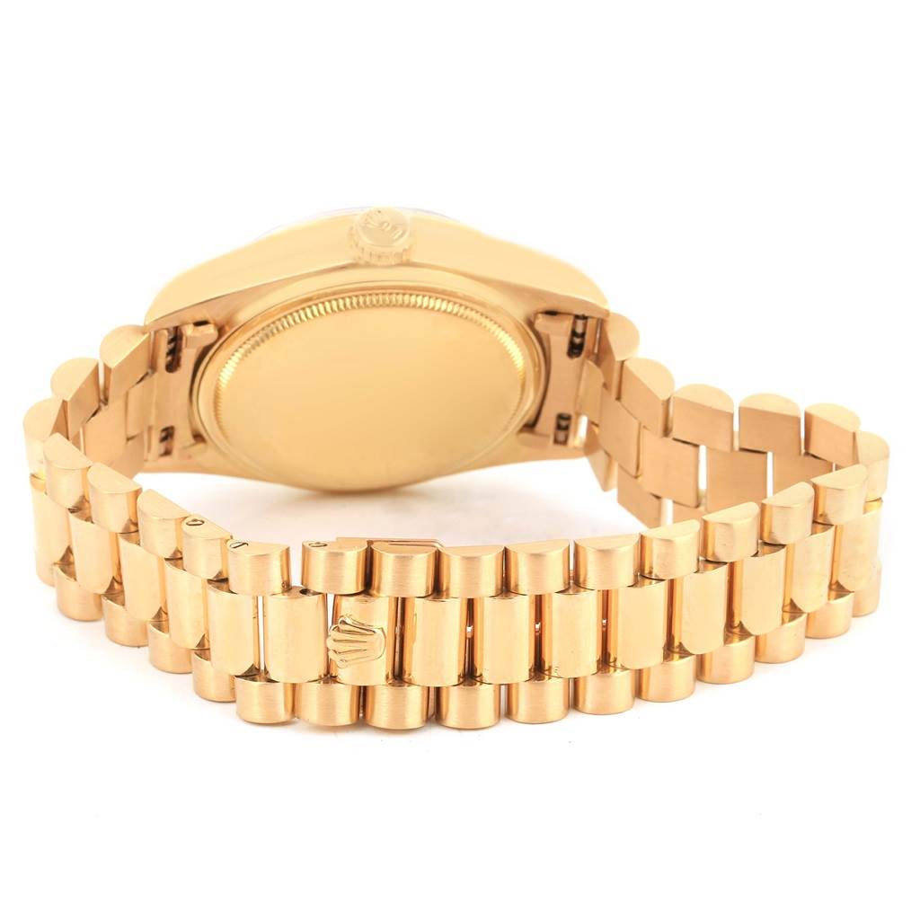 The image shows the back of a Rolex President 18038 Men
s Yellow Gold Blue Dial 18038 Men
s Yellow Gold Blue Dial model watch, highlighting the case back and the signature President bracelet.