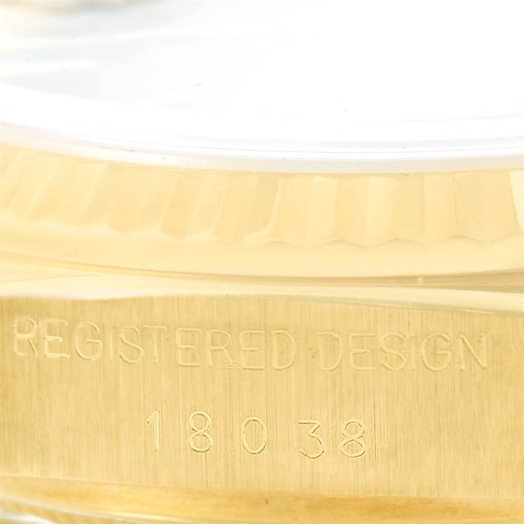 This image shows the model number and side case angle of the Rolex President 18038 Men
s Yellow Gold Blue Dial 18038 Men
s Yellow Gold Blue Dial model watch, focusing on the engraved registered design.