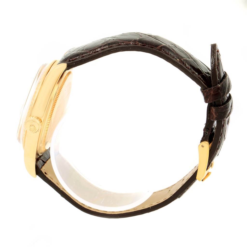 The image shows a side view of a Rolex President 1601 Men's Yellow Gold Champagne Dial 1601 Men's Yellow Gold Champagne Dial model watch, highlighting its gold case and brown leather strap with a gold buckle.