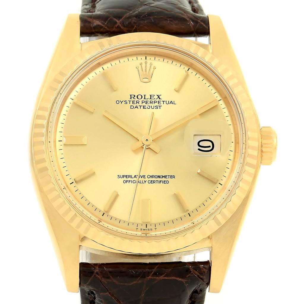 The image shows a front view of the Rolex President 1601 Men's Yellow Gold Champagne Dial 1601 Men's Yellow Gold Champagne Dial model, highlighting its gold face, fluted bezel, and leather strap.