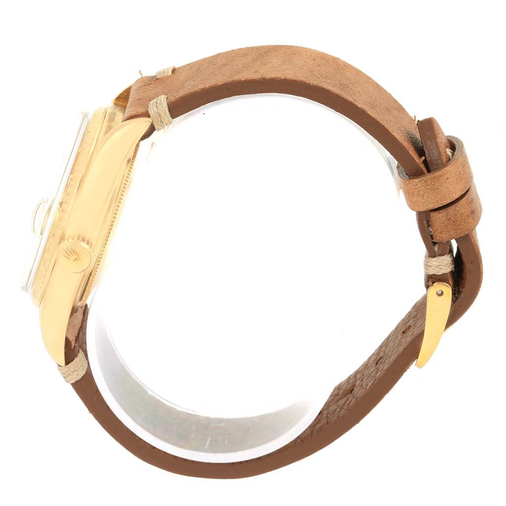 The image shows a side view of a Rolex President 1803 Men
s Yellow Gold Champagne Dial 1803 Men
s Yellow Gold Champagne Dial model watch with a gold case and brown leather strap.