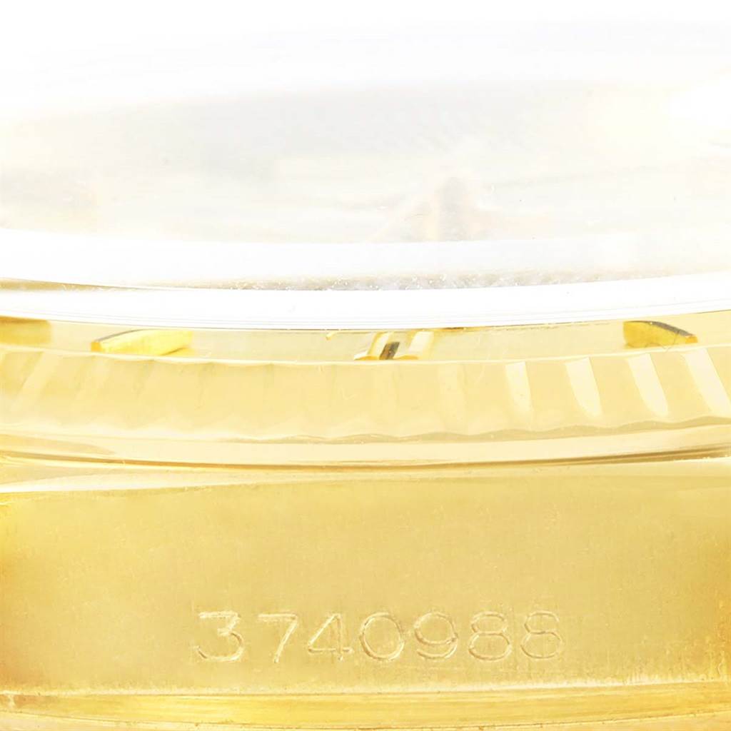 The image shows a close-up of the side of a Rolex President 1803 Men
s Yellow Gold Champagne Dial 1803 Men
s Yellow Gold Champagne Dial model watch, focusing on the serial number engraved on the gold case.