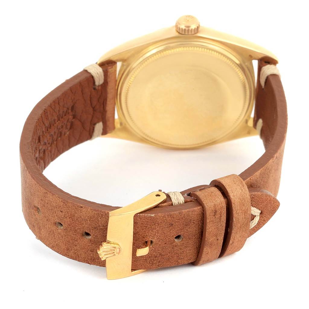 The image shows the back case and buckle of a Rolex President 1803 Men
s Yellow Gold Champagne Dial 1803 Men
s Yellow Gold Champagne Dial model watch at an angled rear view.