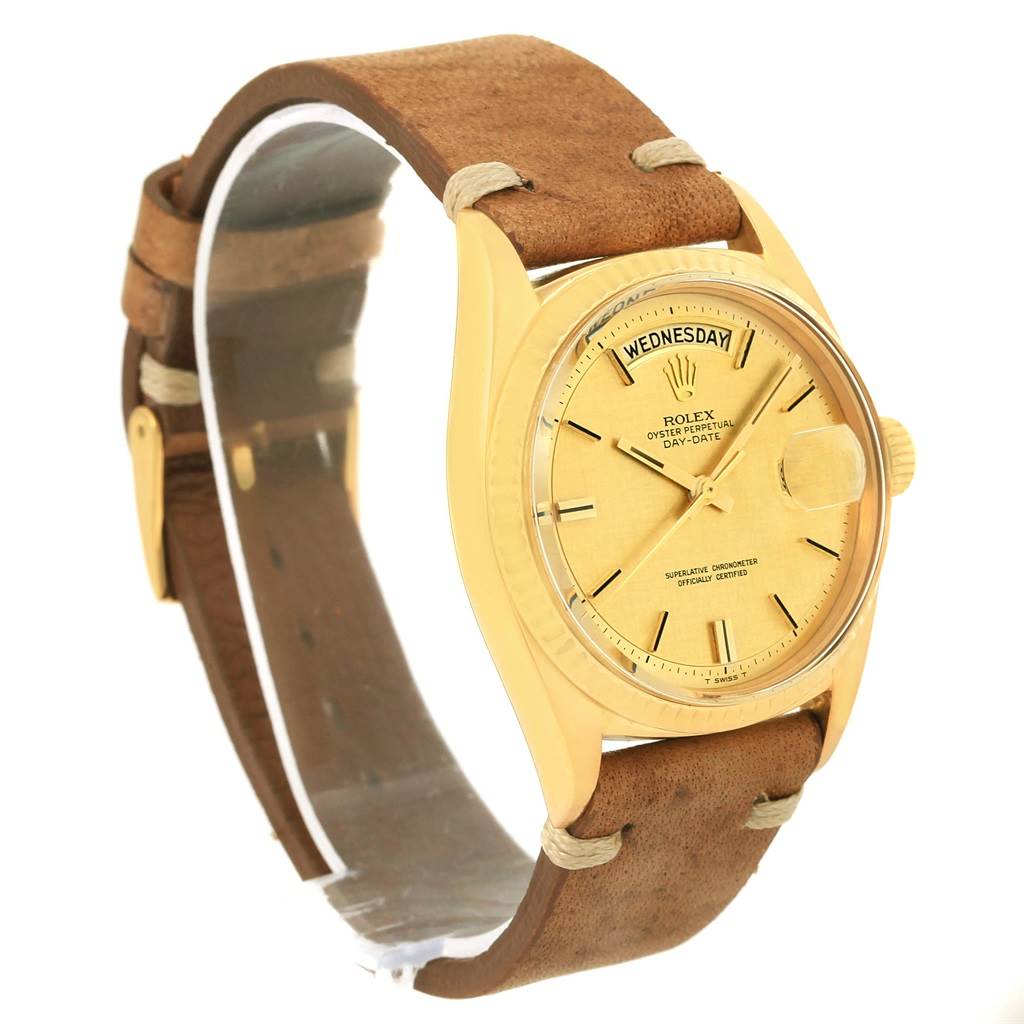The Rolex President 1803 Men
s Yellow Gold Champagne Dial 1803 Men
s Yellow Gold Champagne Dial model watch is shown at a three-quarter angle, showcasing its gold case, tan leather strap, and day-date display.