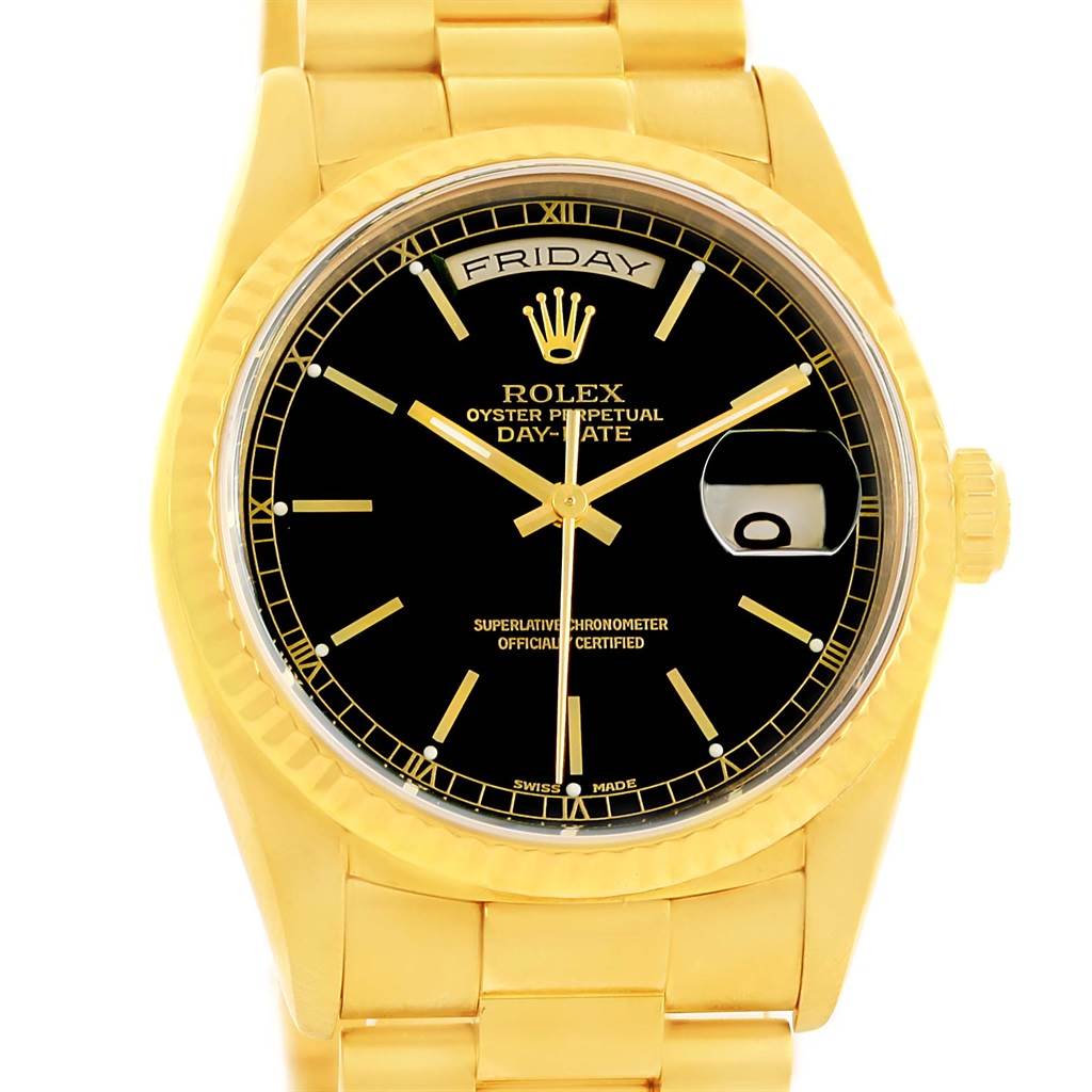 The image shows a frontal view of a Rolex President 18238 Men
s Yellow Gold Black Dial 18238 Men
s Yellow Gold Black Dial model watch, featuring its black dial, day-date display, and gold band.