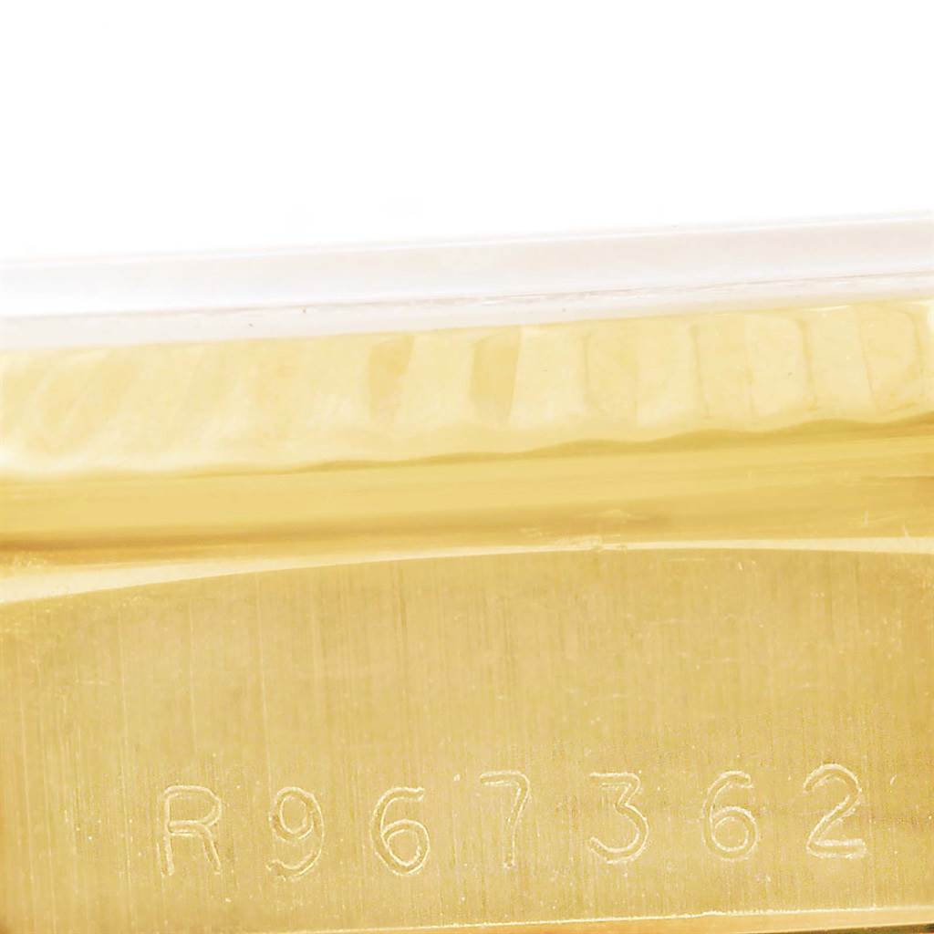 This close-up image shows the serial number engraved on the gold case of a Rolex President 18238 Men
s Yellow Gold Black Dial 18238 Men
s Yellow Gold Black Dial model watch.