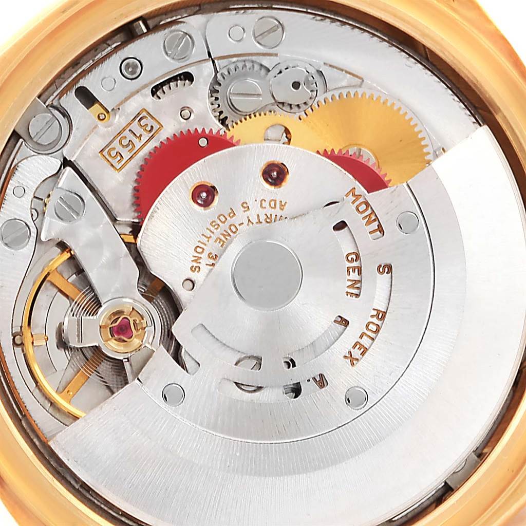 This image shows a close-up of the movement mechanism of a Rolex President 18238 Men
s Yellow Gold Black Dial 18238 Men
s Yellow Gold Black Dial model watch, highlighting gears, cogs, and inscriptions.