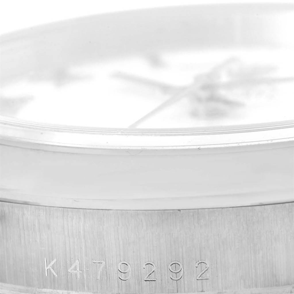 This close-up angle shows the side of the Rolex President 118209 Men's White Gold White Dial 118209 Men's White Gold White Dial model, focusing on the engraved serial number and part of the dial.