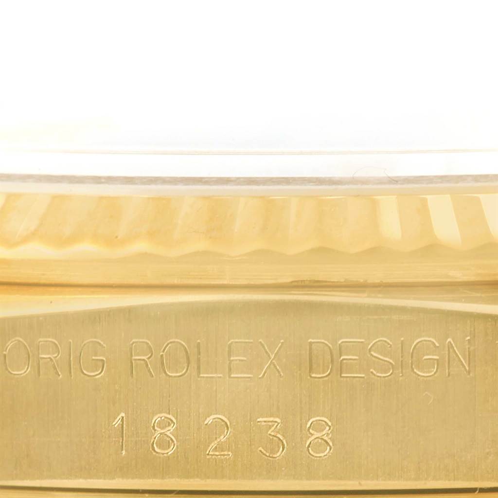 The image shows a close-up of the side of a Rolex President 18238 Men
s Yellow Gold Champagne Dial 18238 Men
s Yellow Gold Champagne Dial model, highlighting the engraved case number "18238."