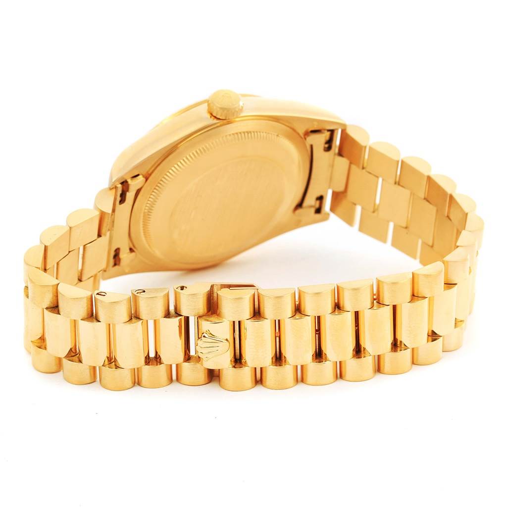 The image shows the backside and partially open bracelet of a Rolex President 18238 Men
s Yellow Gold Champagne Dial 18238 Men
s Yellow Gold Champagne Dial model watch.