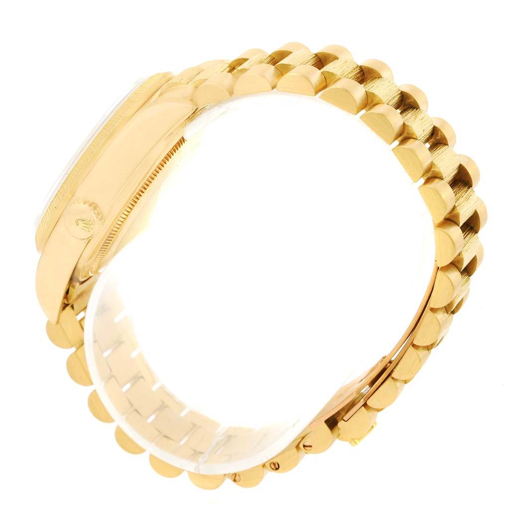 The image shows a side view of the Rolex President 18078 Men
s Yellow Gold White Dial 18078 Men
s Yellow Gold White Dial model watch, highlighting the case, bezel, and gold bracelet.