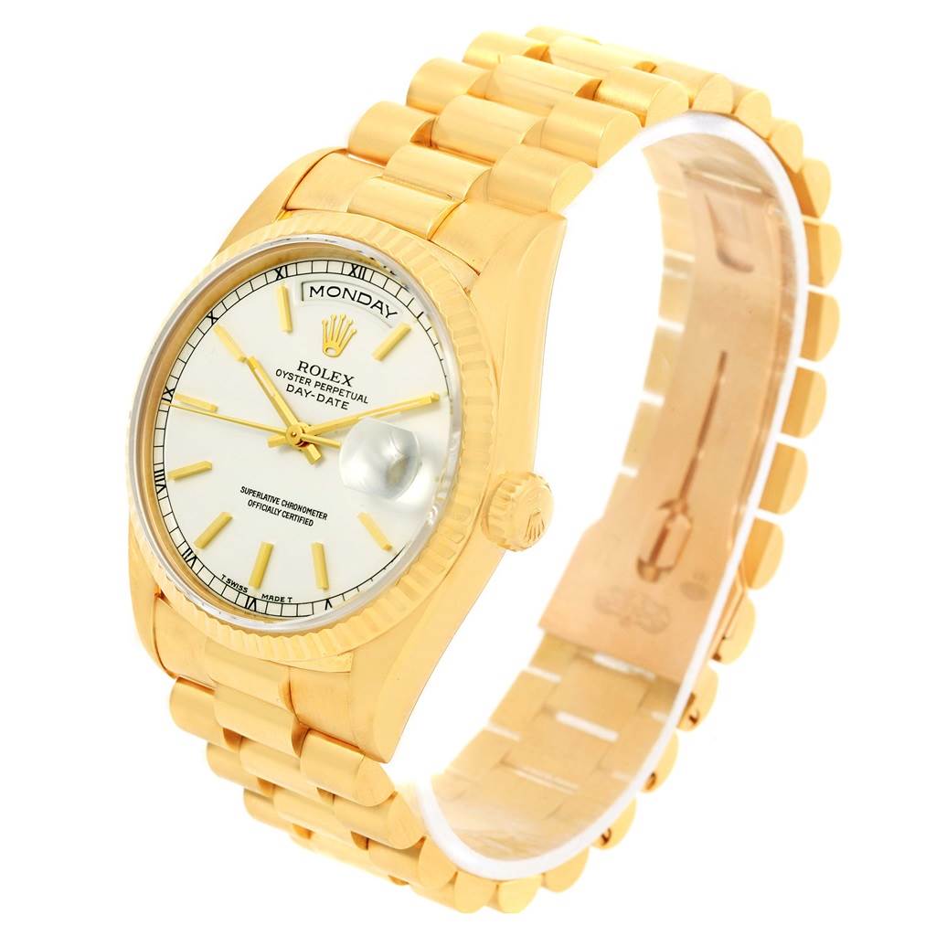 This image shows a Rolex President 18238 Men
s Yellow Gold White Dial 18238 Men
s Yellow Gold White Dial Day-Date watch at a three-quarter angle, highlighting the dial, bezel, crown, and bracelet.