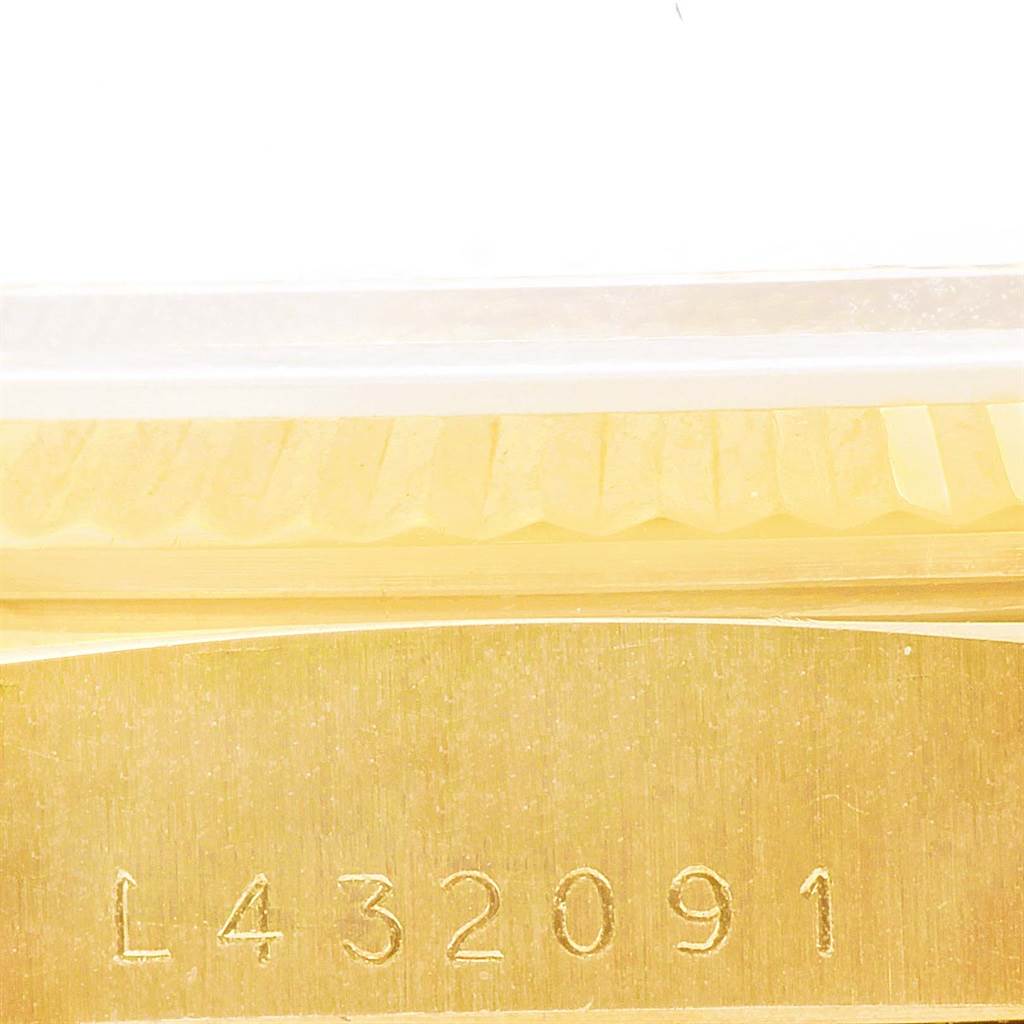The image shows a close-up of the serial number inscribed on the gold case of a Rolex President 18238 Men
s Yellow Gold White Dial 18238 Men
s Yellow Gold White Dial model watch.