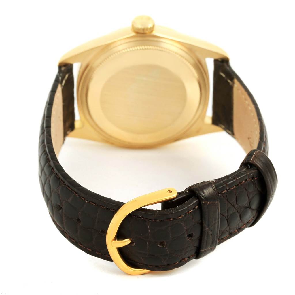 The image shows the case back and the leather strap of a Rolex President 1807 Men
s Yellow Gold Champagne Dial 1807 Men
s Yellow Gold Champagne Dial model watch.