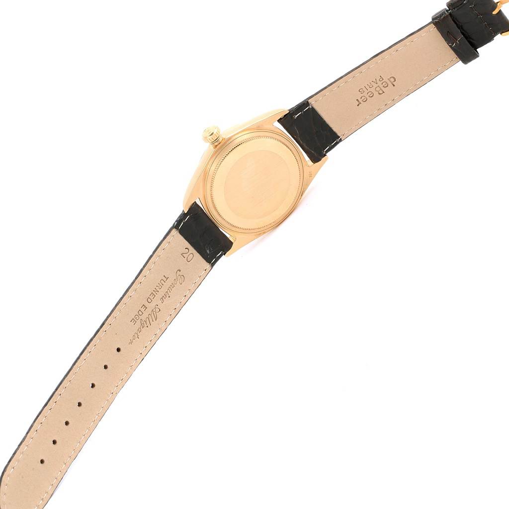 The image shows the back view of a Rolex President 1807 Men
s Yellow Gold Champagne Dial 1807 Men
s Yellow Gold Champagne Dial model watch, displaying the case back and leather strap.