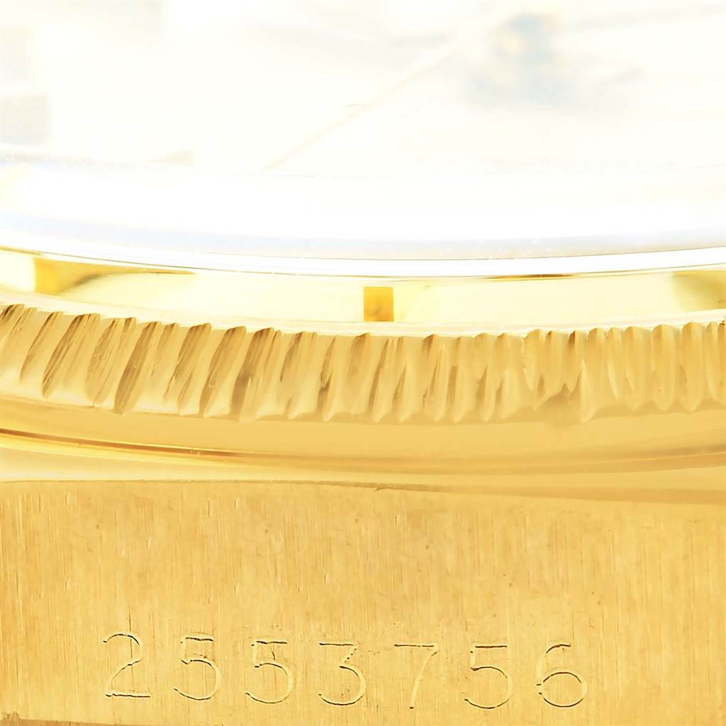 This image shows a close-up angle of the Rolex President 1807 Men
s Yellow Gold Champagne Dial 1807 Men
s Yellow Gold Champagne Dial model, focusing on the bezel and part of the case with serial numbers.