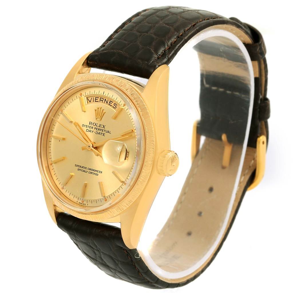 This image shows a Rolex President 1807 Men
s Yellow Gold Champagne Dial 1807 Men
s Yellow Gold Champagne Dial model watch at a three-quarter angle, highlighting its gold case, dial, and dark leather strap.