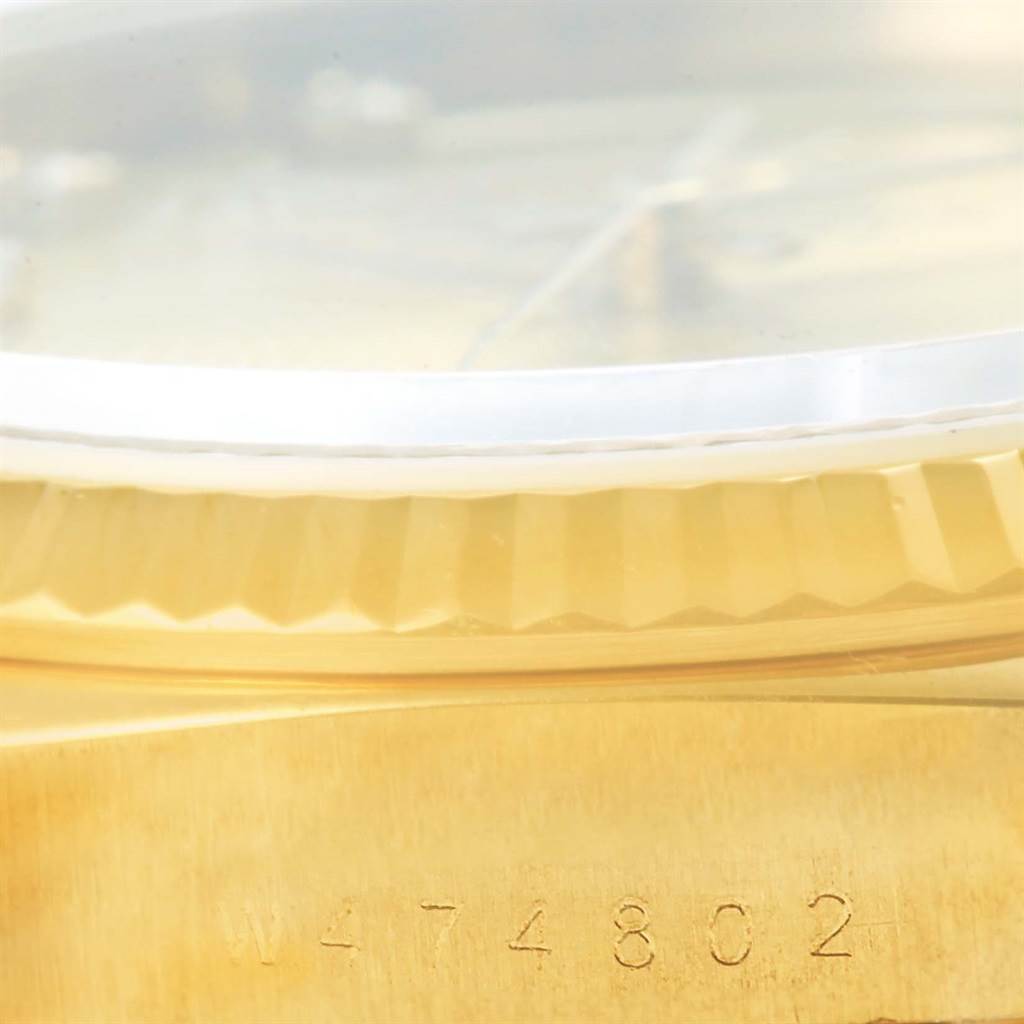 This close-up image shows the serial number and fluted bezel of a Rolex President 18238 Men's Yellow Gold Champagne Dial 18238 Men's Yellow Gold Champagne Dial model watch.