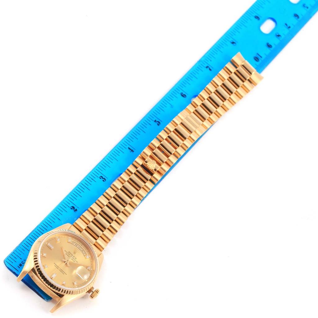 The image shows a Rolex President 18238 Men's Yellow Gold Champagne Dial 18238 Men's Yellow Gold Champagne Dial model watch laid flat next to a blue ruler, displaying the full length of the watch and its bracelet.
