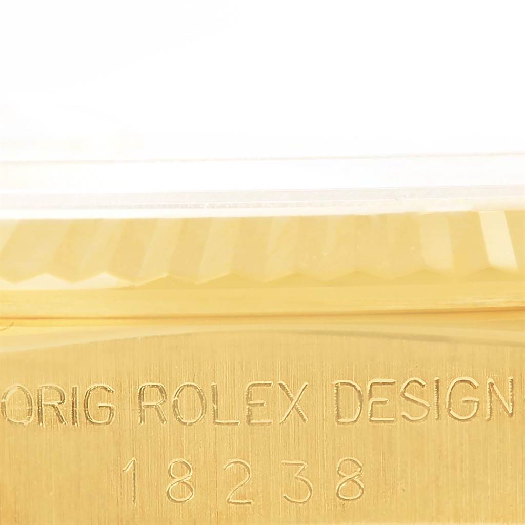 Close-up view of the model and serial number on the case of a Rolex President 18238 Men
s Yellow Gold Champagne Dial 18238 Men
s Yellow Gold Champagne Dial watch, showing "ORIG ROLEX DESIGN 18238."