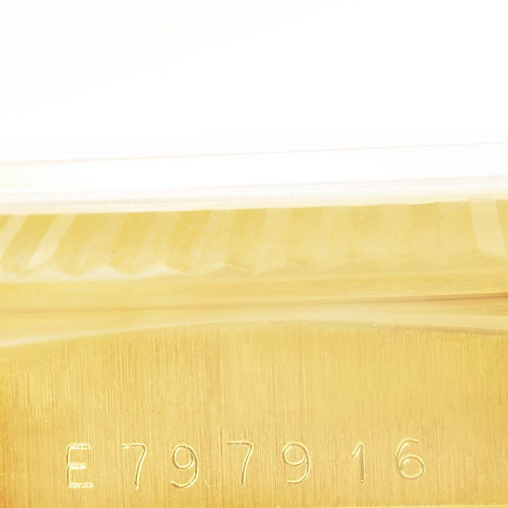 This image shows a close-up of the serial number and part of the fluted bezel on a Rolex President 18238 Men
s Yellow Gold Champagne Dial 18238 Men
s Yellow Gold Champagne Dial model watch.