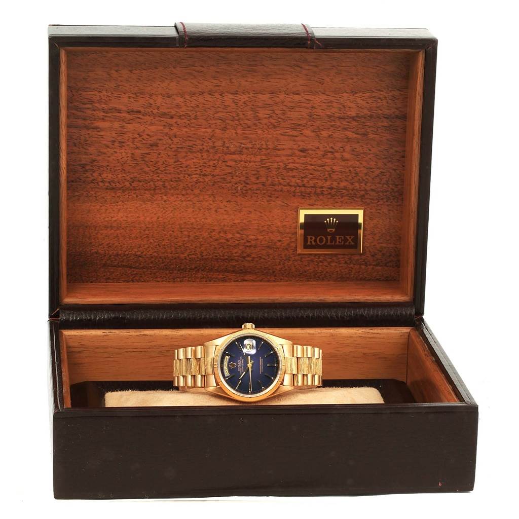 The Rolex President 18078 Men's Yellow Gold Blue Dial 18078 Men's Yellow Gold Blue Dial model watch is displayed front and center within an open wooden Rolex box.