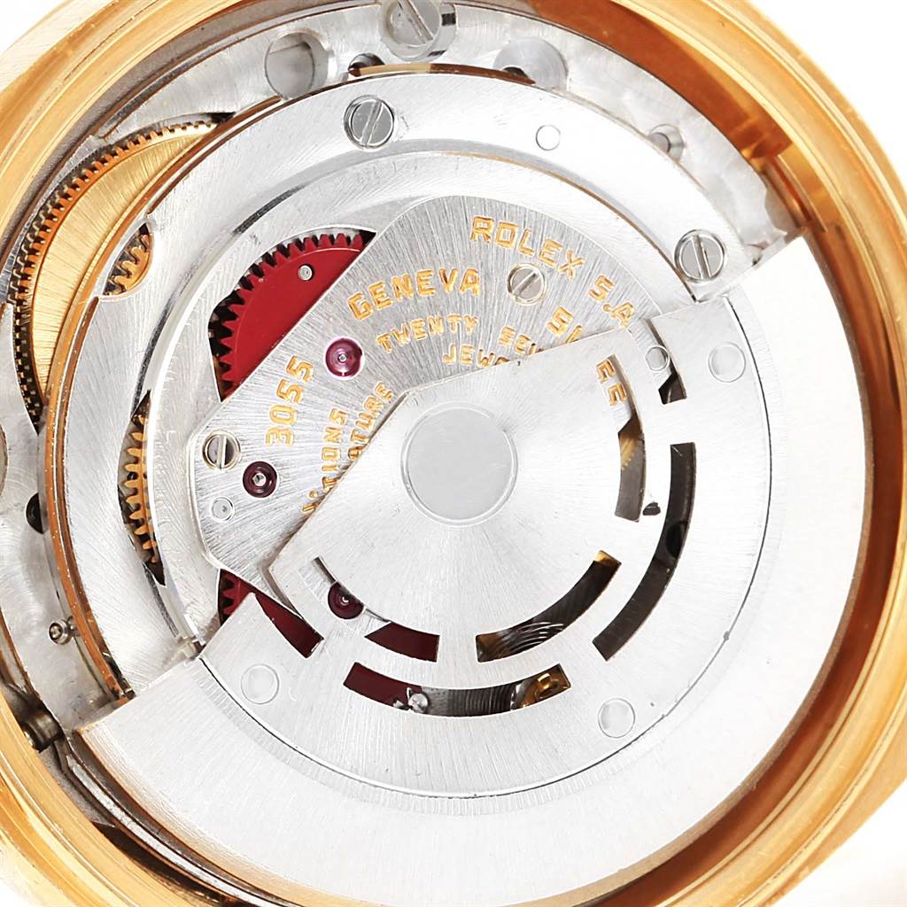 The image shows a close-up of the internal mechanism of a Rolex President 18078 Men's Yellow Gold Blue Dial 18078 Men's Yellow Gold Blue Dial model watch, highlighting its gears and movement components.