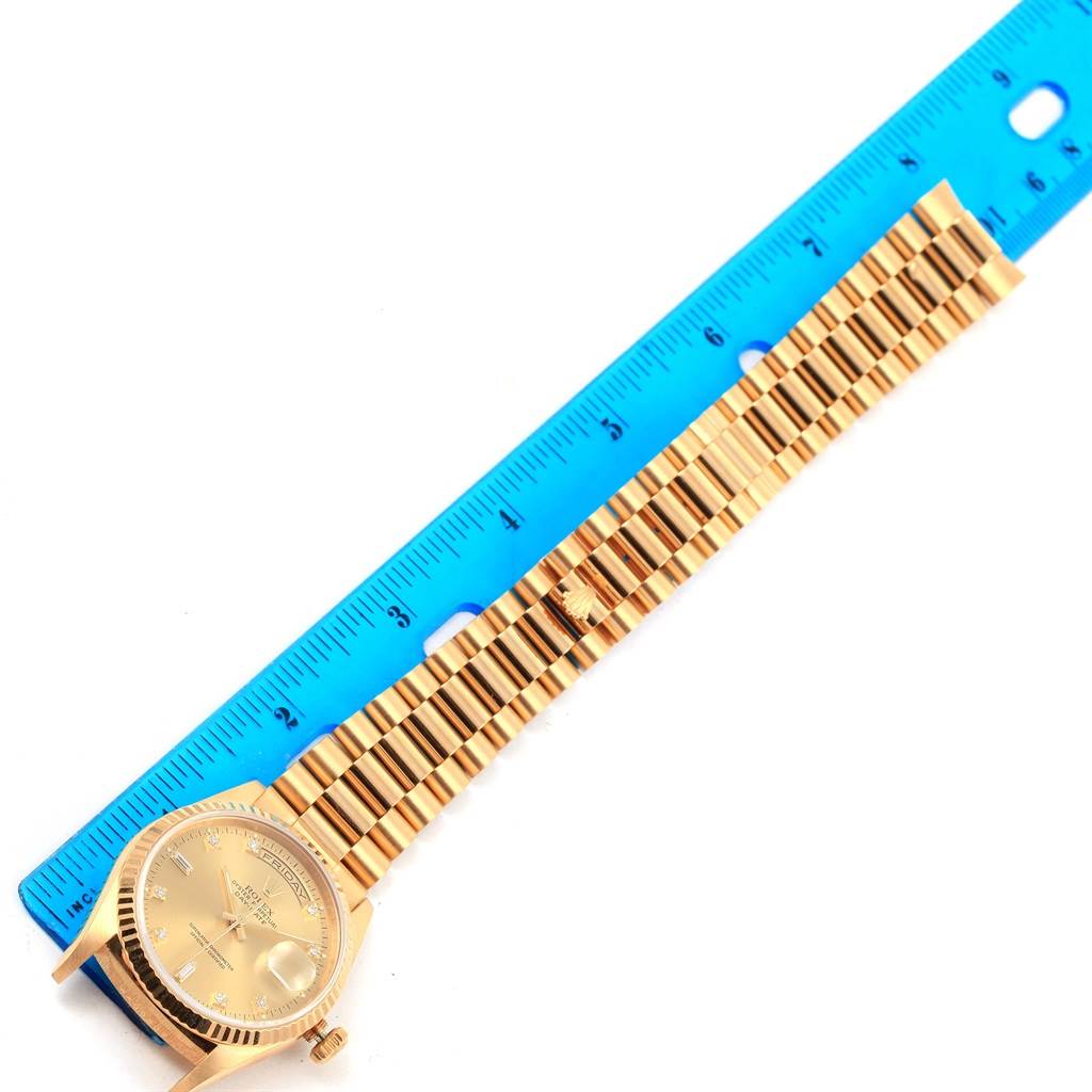 The image shows a Rolex President 18238 Men's Yellow Gold Champagne Dial 18238 Men's Yellow Gold Champagne Dial model watch laid flat next to a blue ruler, highlighting the bracelet and face.