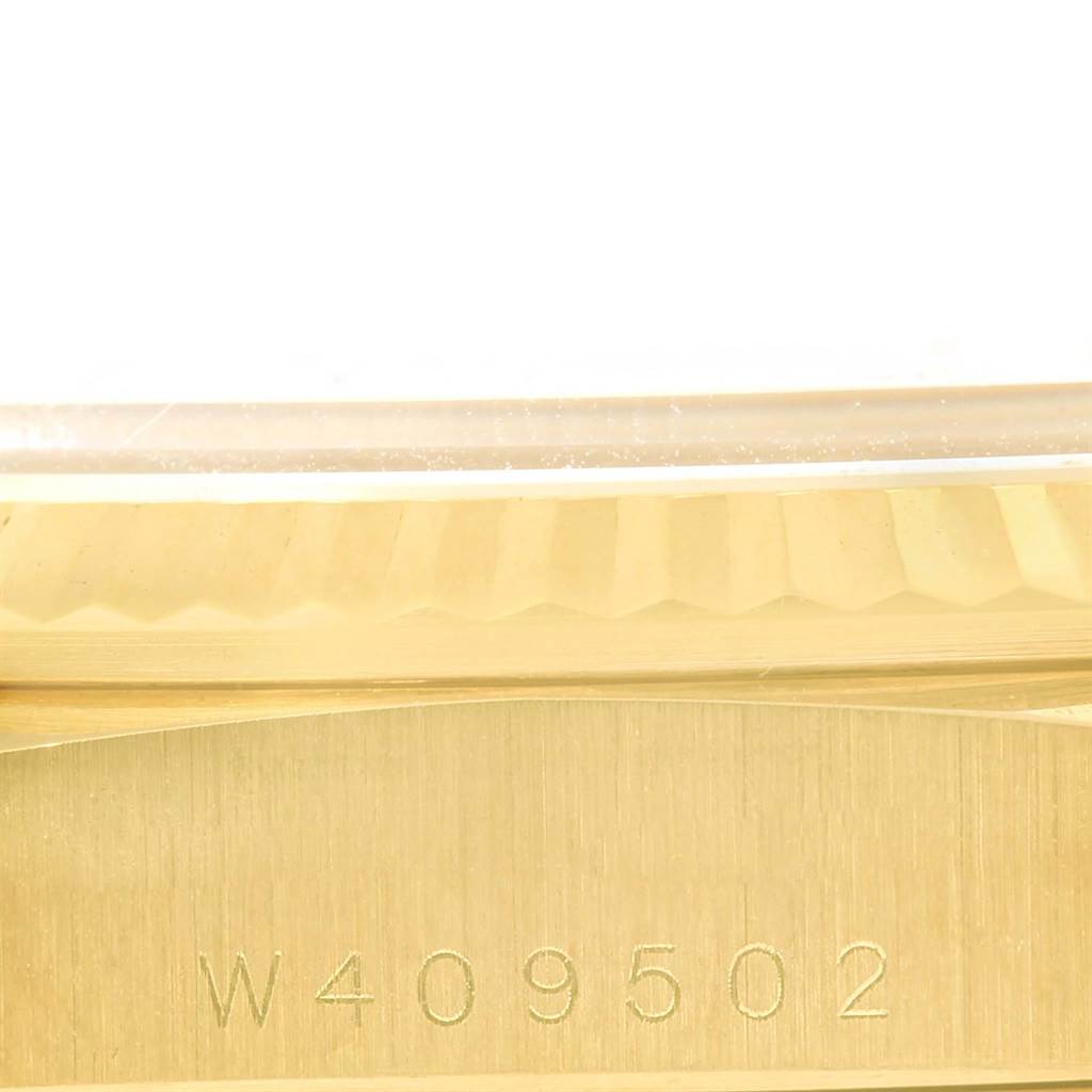 This close-up image shows the serial number engraved on the gold case side of a Rolex President 18238 Men's Yellow Gold Champagne Dial 18238 Men's Yellow Gold Champagne Dial model watch.