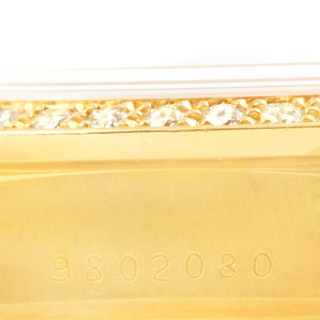 This close-up image shows the detailed side of a Rolex President 18038 Men's Yellow Gold Black Dial 18038 Men's Yellow Gold Black Dial model watch with diamonds and the serial number 9802080.