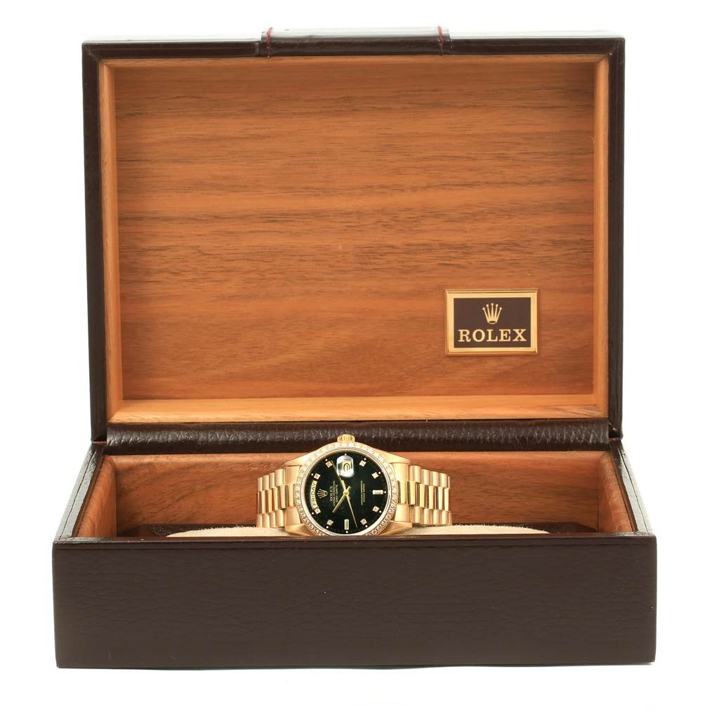 The Rolex President 18038 Men's Yellow Gold Black Dial 18038 Men's Yellow Gold Black Dial model watch is shown from the front, displayed inside an open wooden box.
